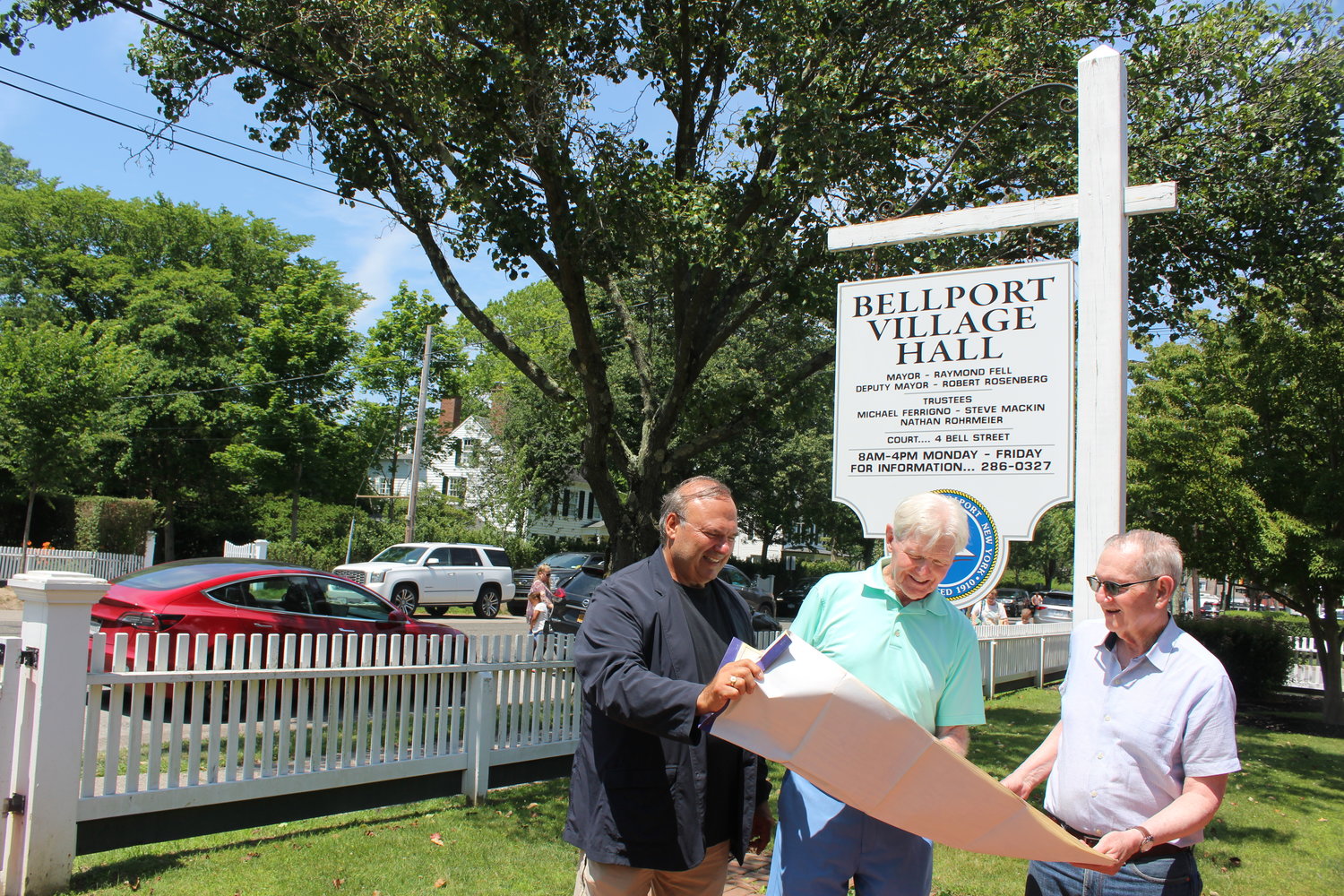 Village clerk John Kocay, mayor Ray Fell, and Environmental Committee chair Marc Rauch look over village possibilities for a Johnson Controls survey.